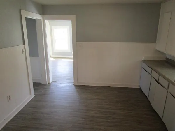 a view of hallway with wooden floor