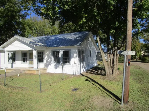 a view of a house with backyard porch and sitting area