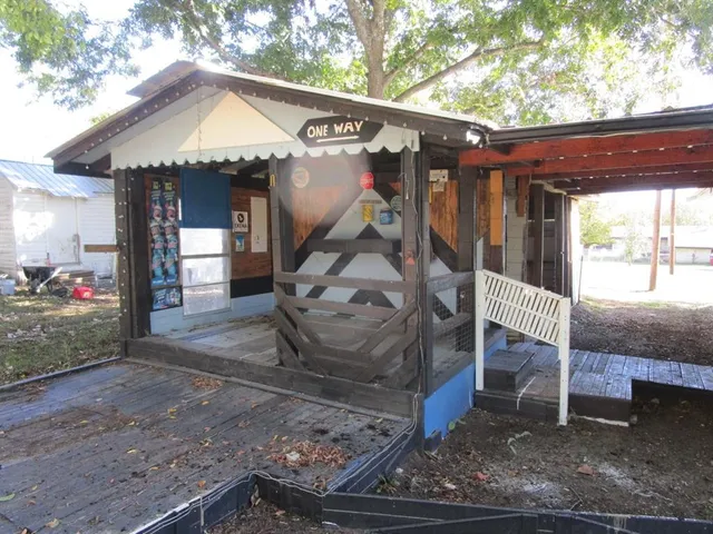 a view of a house with a porch and a yard