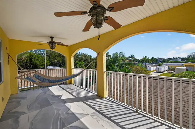 a view of a livingroom with furniture staircase and a ceiling fan