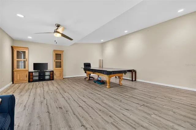 a view of a livingroom with furniture ceiling fan and window