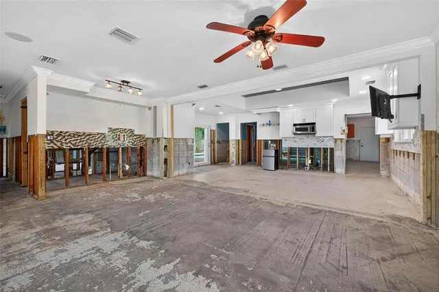 a view of a livingroom with a red and white umbrella