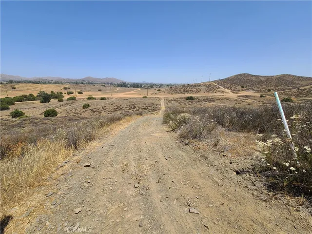 a view of a large building with mountains in the background