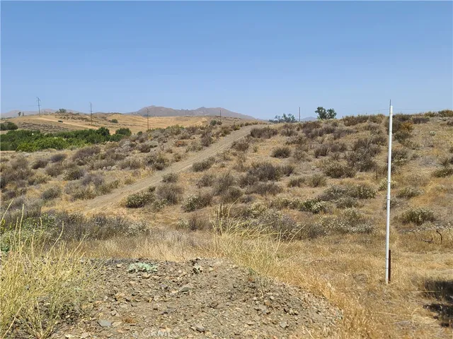 a view of a dry yard with a mountain