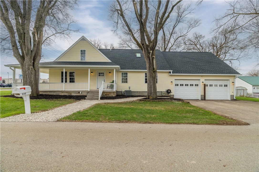 This charming residence features a welcoming porch and practical attached garage.