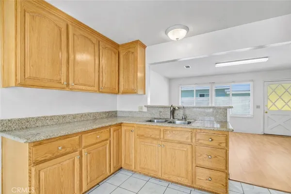 a kitchen with granite countertop stainless steel appliances a sink and cabinets