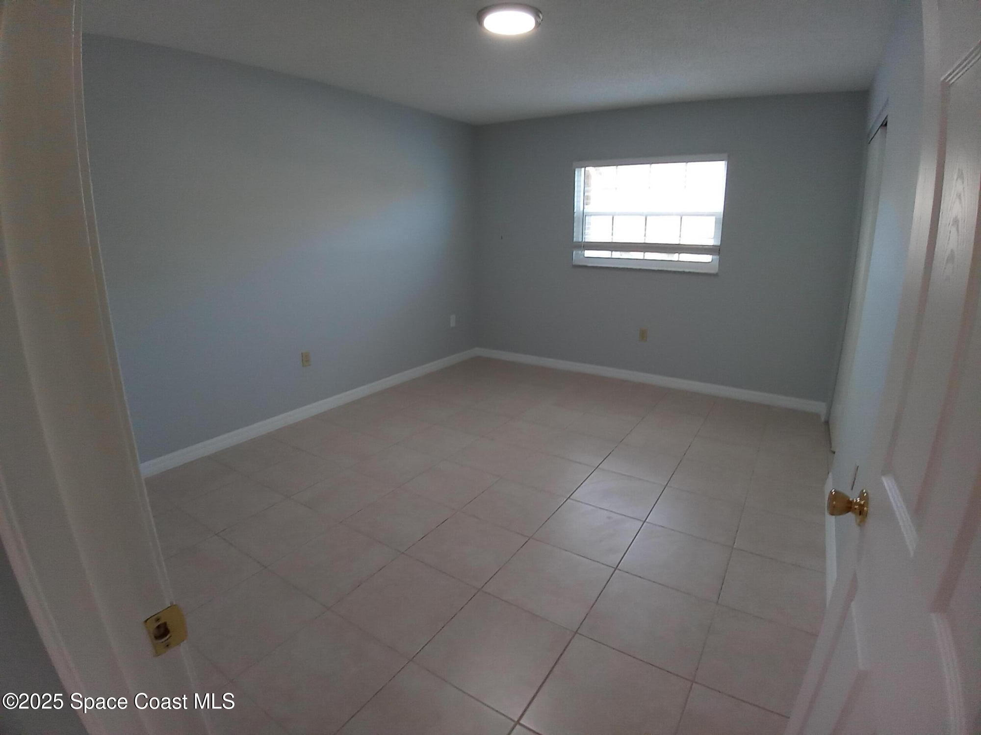 183 Ulster Lane Melbourne, FL 32935 - Photo 14 of 43 an empty room with a window