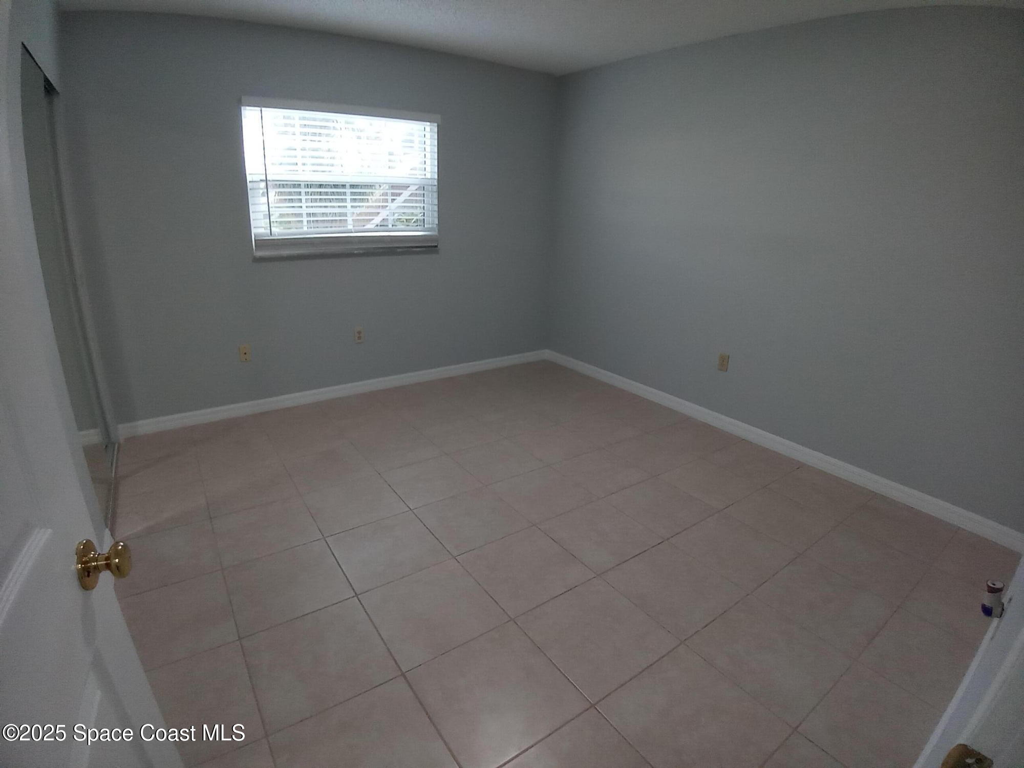 183 Ulster Lane Melbourne, FL 32935 - Photo 18 of 43 an empty room with a window