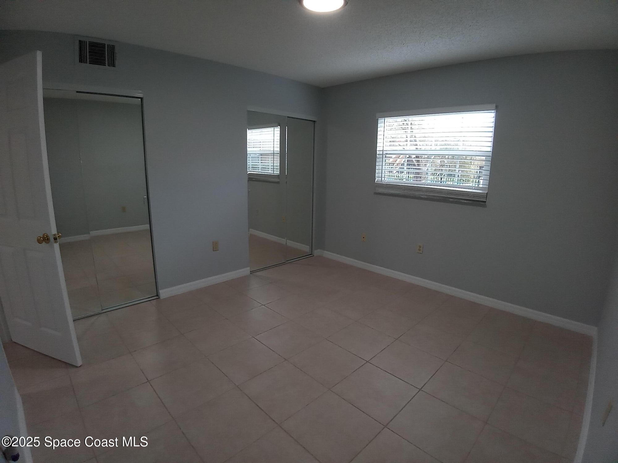 183 Ulster Lane Melbourne, FL 32935 - Photo 20 of 43 an empty room with windows