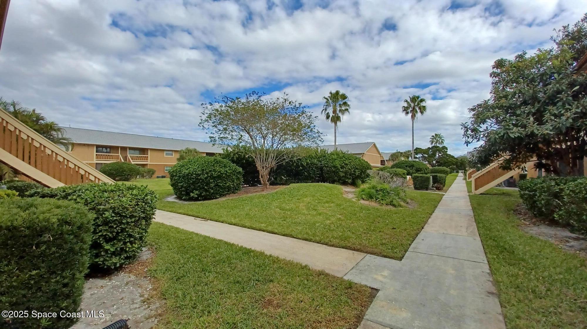 183 Ulster Lane Melbourne, FL 32935 - Photo 23 of 43 a view of a garden with plants and a pathway