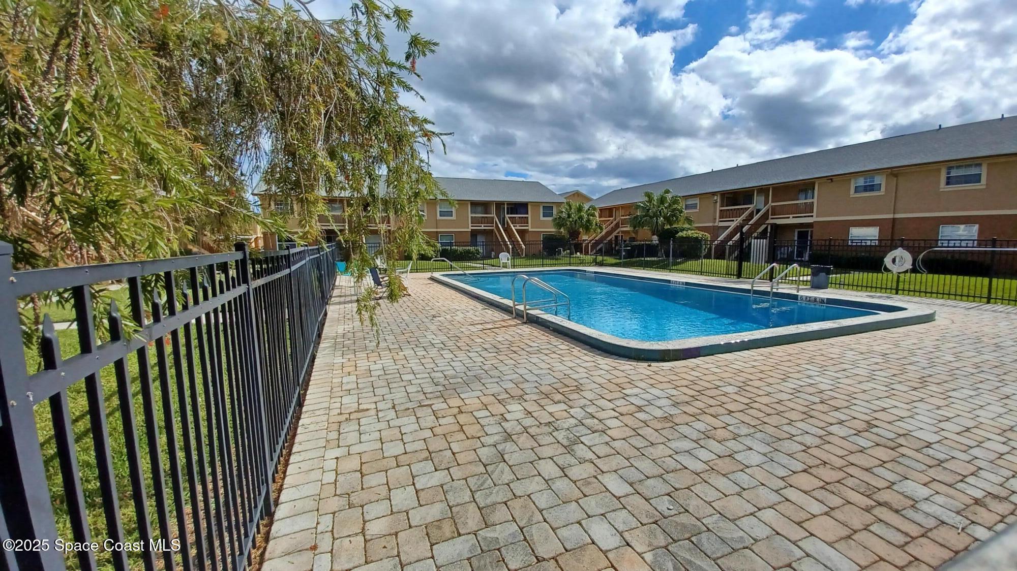 183 Ulster Lane Melbourne, FL 32935 - Photo 28 of 43 a view of a swimming pool with an outdoor space and balcony