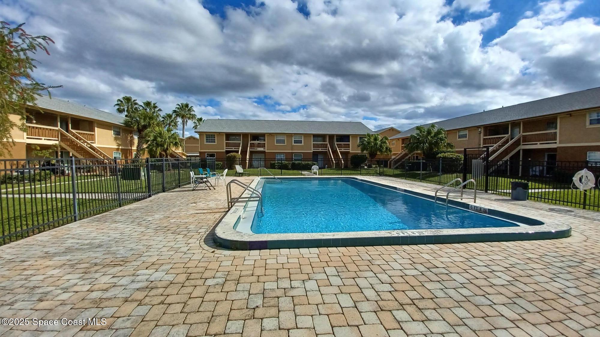 183 Ulster Lane Melbourne, FL 32935 - Photo 29 of 43 a view of a swimming pool with a yard