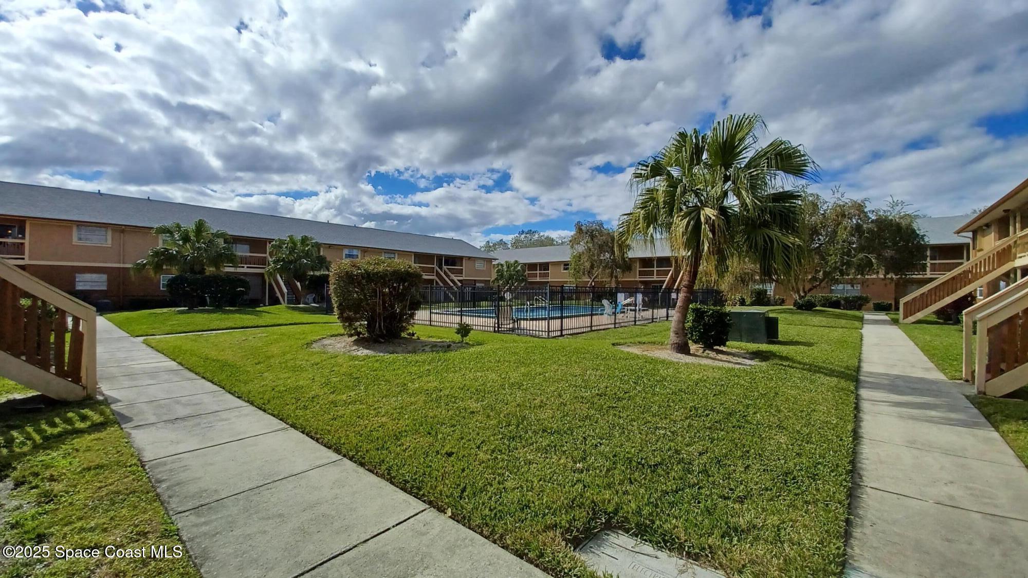 183 Ulster Lane Melbourne, FL 32935 - Photo 30 of 43 a view of a park with swings and slides