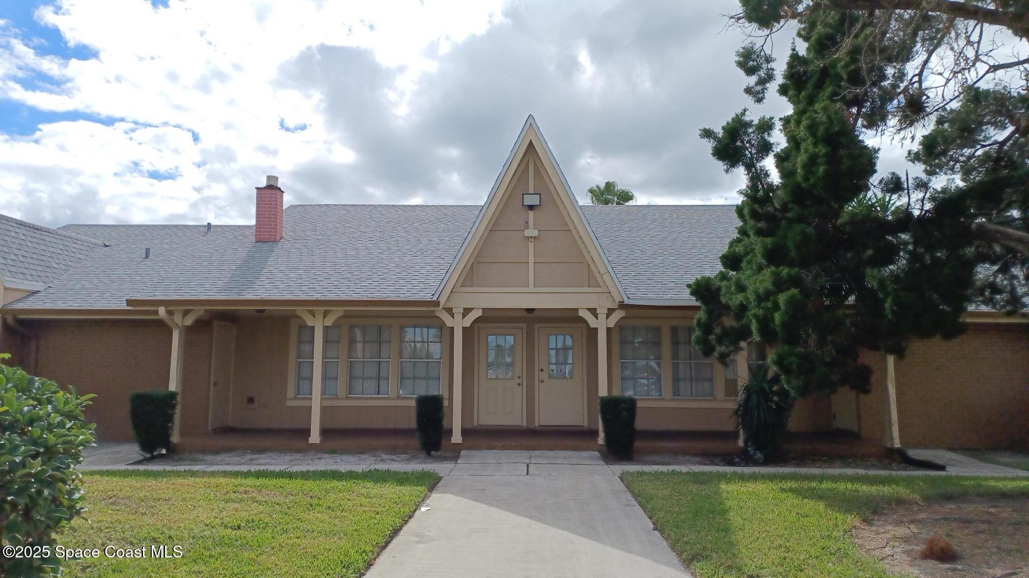 183 Ulster Lane Melbourne, FL 32935 - Photo 34 of 43 front view of a house with a yard