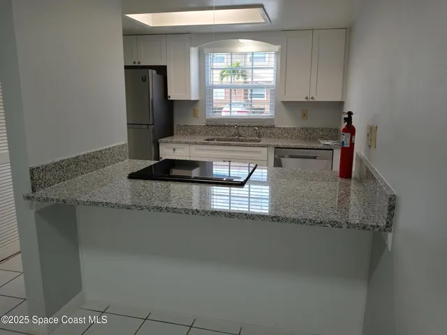 a kitchen with granite countertop a sink and a granite counter tops