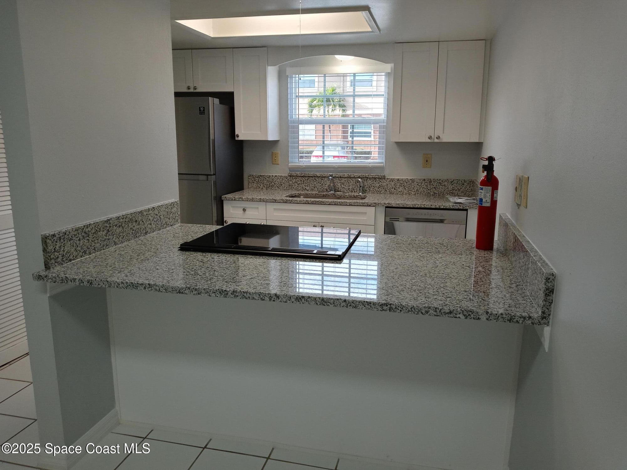 183 Ulster Lane Melbourne, FL 32935 - Photo 7 of 43 a kitchen with granite countertop a sink and a granite counter tops