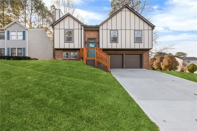 a front view of house with yard and green space