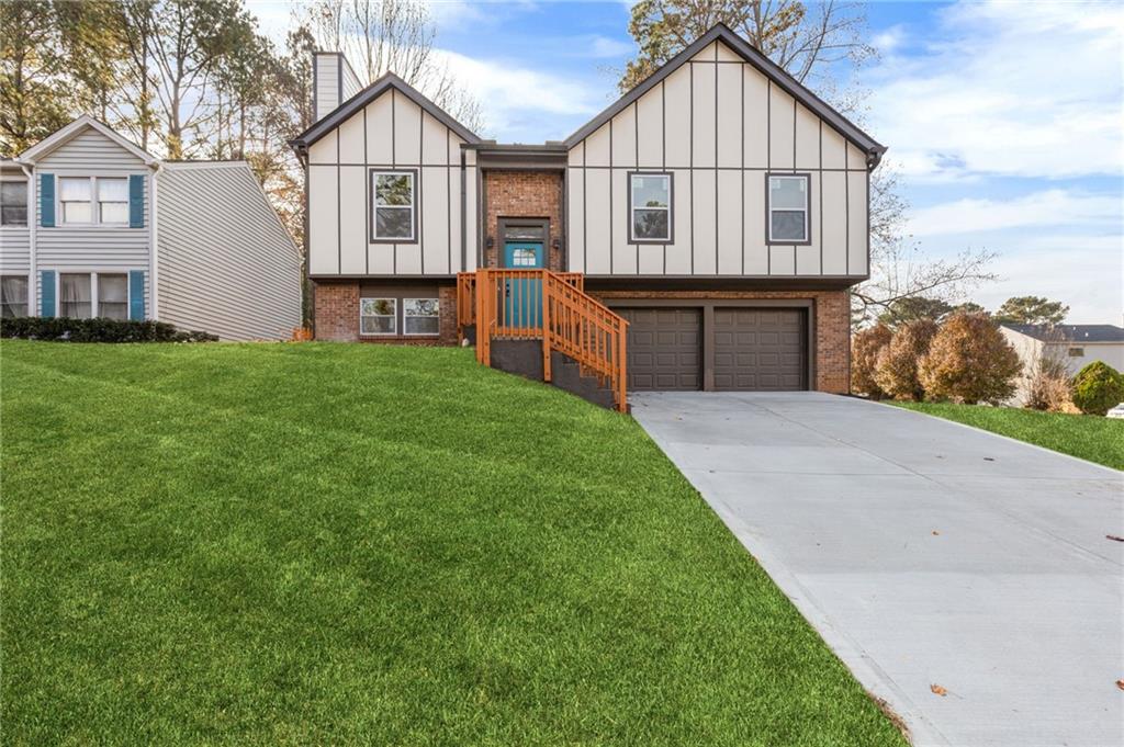 a front view of house with yard and green space