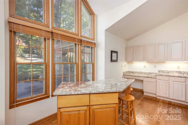a kitchen with granite countertop sink and cabinets