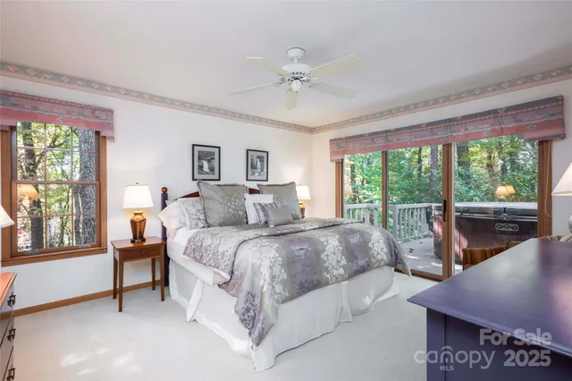 a spacious bedroom with a bed and a large window