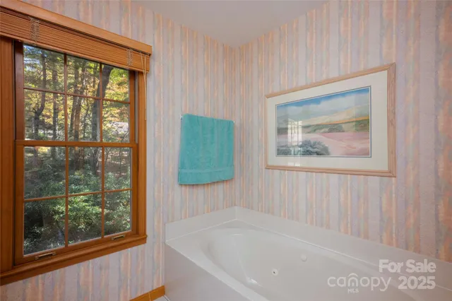 a white bath tub sitting next to a window