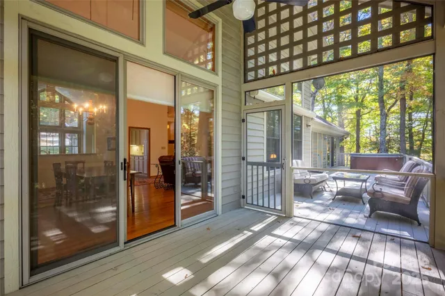 a view of a porch with a table and chairs