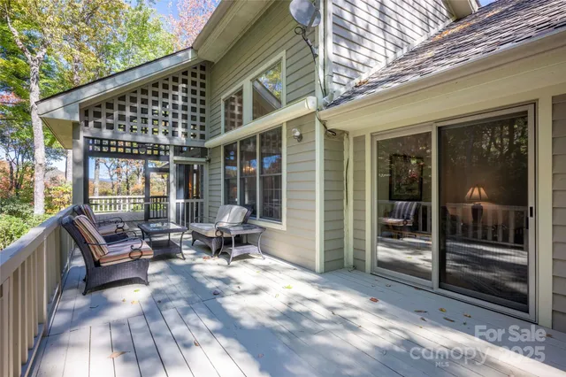 a patio with glass door and outdoor seating