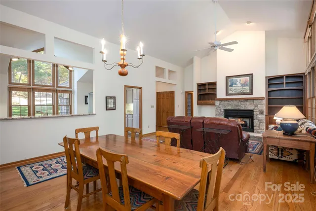 a living room with furniture a fireplace and a chandelier