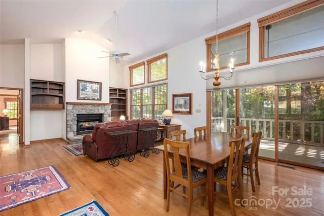 a living room with furniture a fireplace and a floor to ceiling window