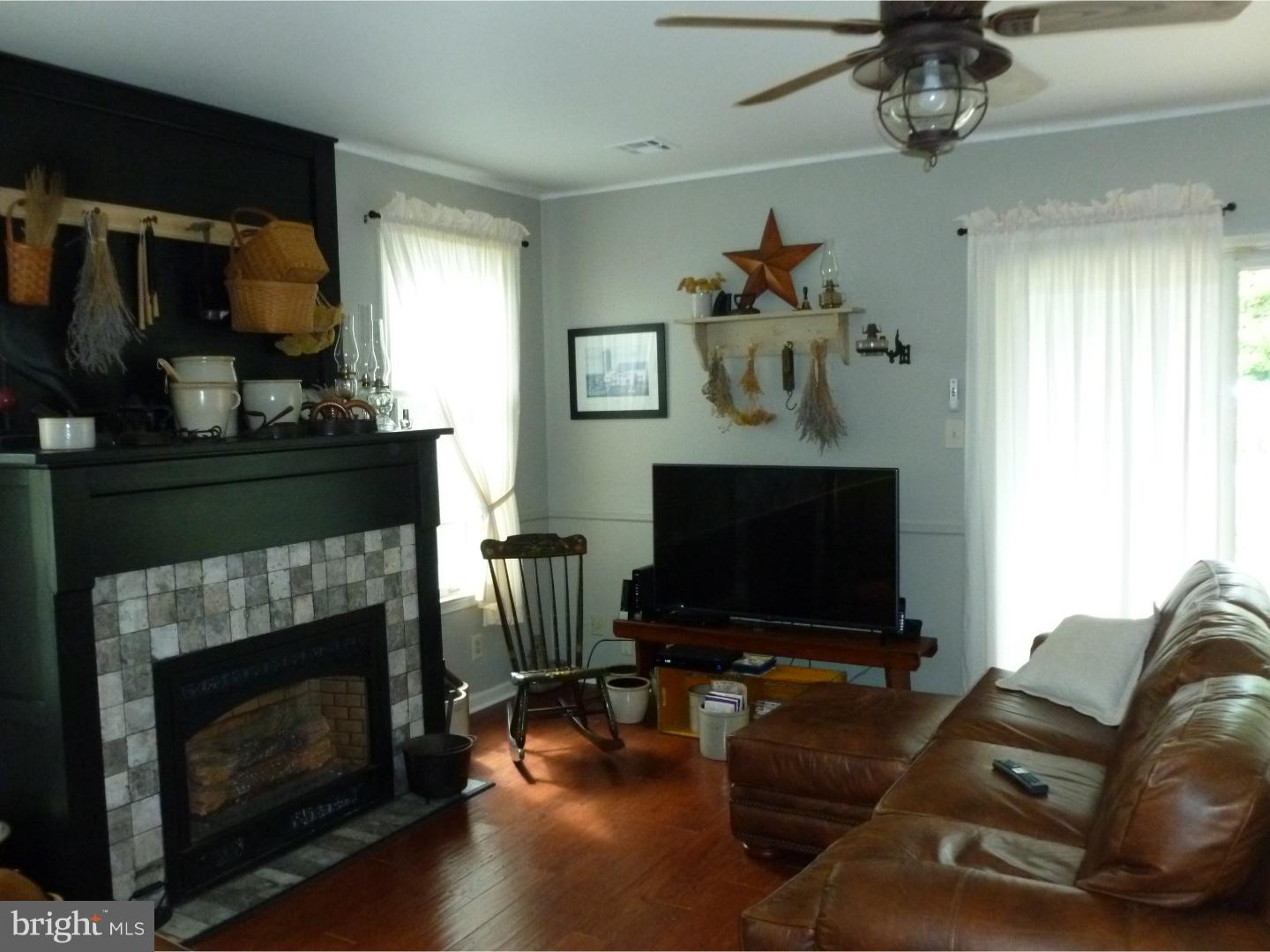37 Manchester Road Eastampton, NJ 08060 - Photo 15 of 25 a living room with furniture a flat screen tv and a fireplace