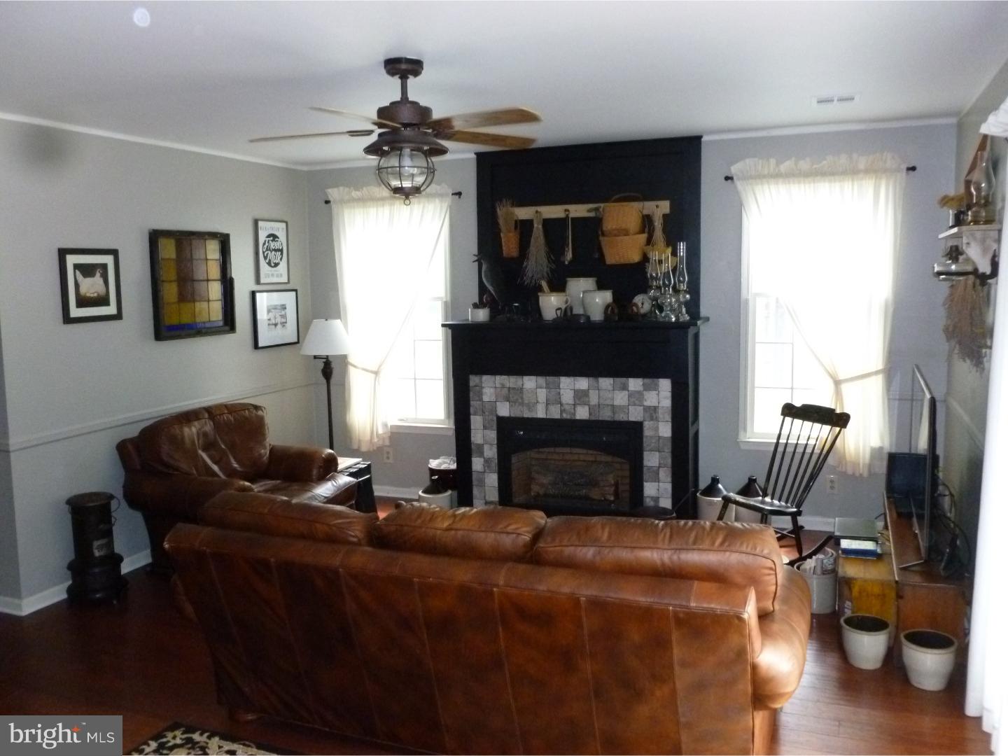 37 Manchester Road Eastampton, NJ 08060 - Photo 16 of 25 a living room with furniture a flat screen tv and a fireplace