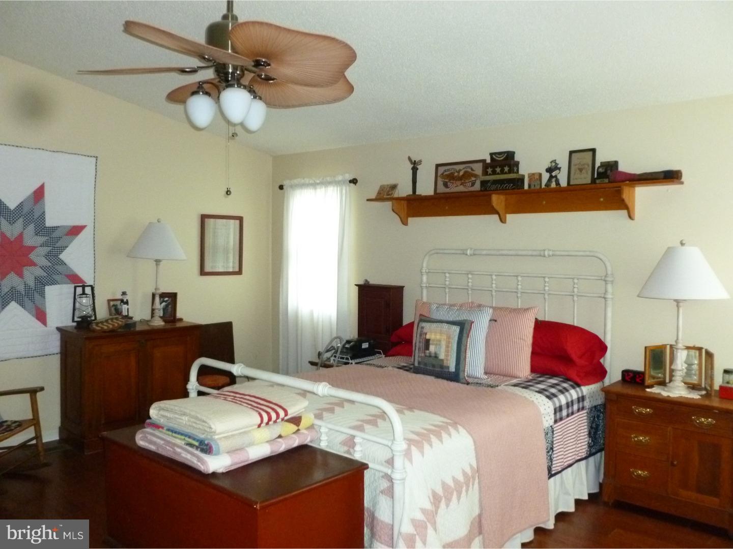 37 Manchester Road Eastampton, NJ 08060 - Photo 18 of 25 a bedroom with a bed and a chandelier