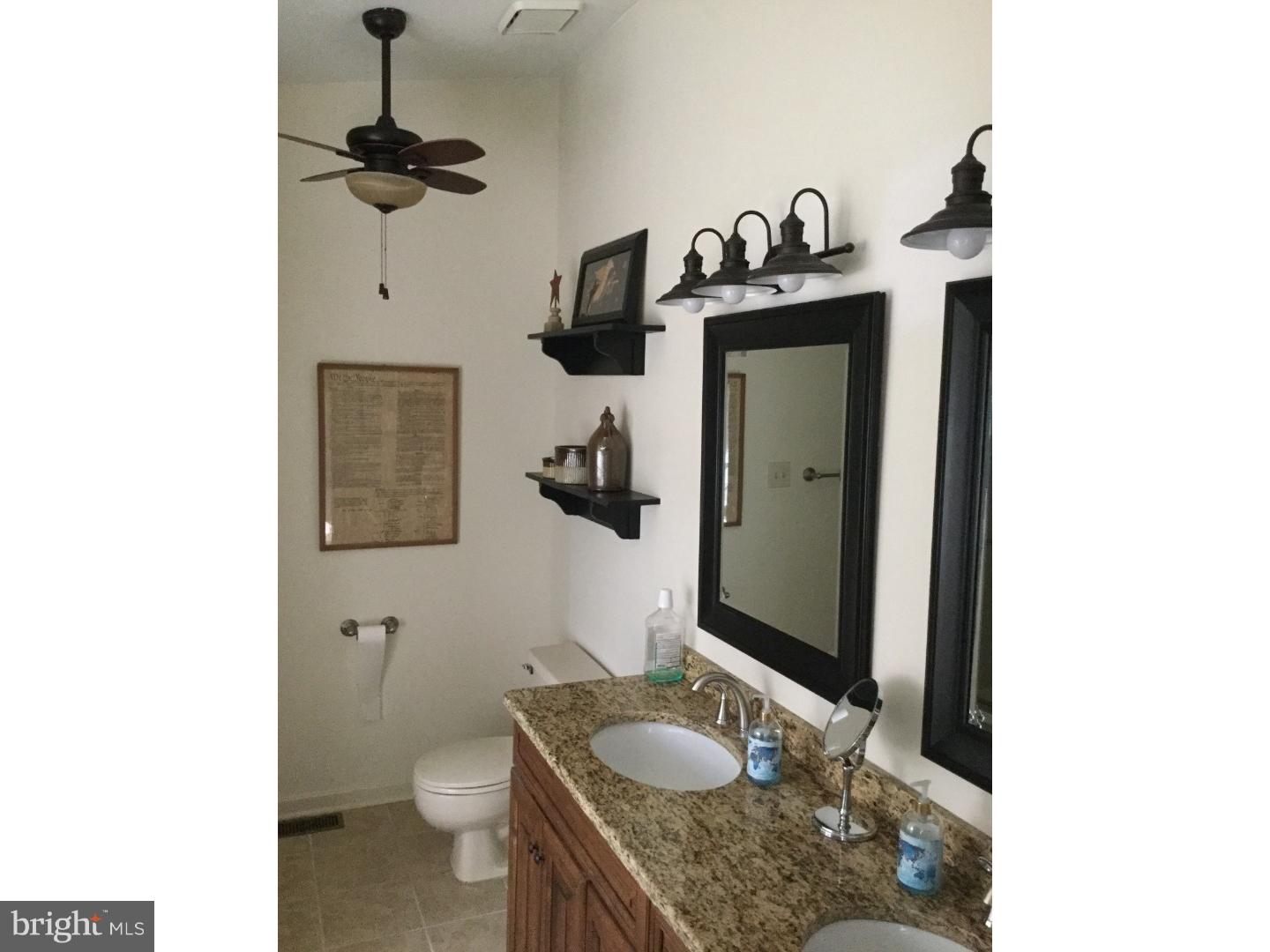 37 Manchester Road Eastampton, NJ 08060 - Photo 20 of 25 a bathroom with a sink a mirror and toilet