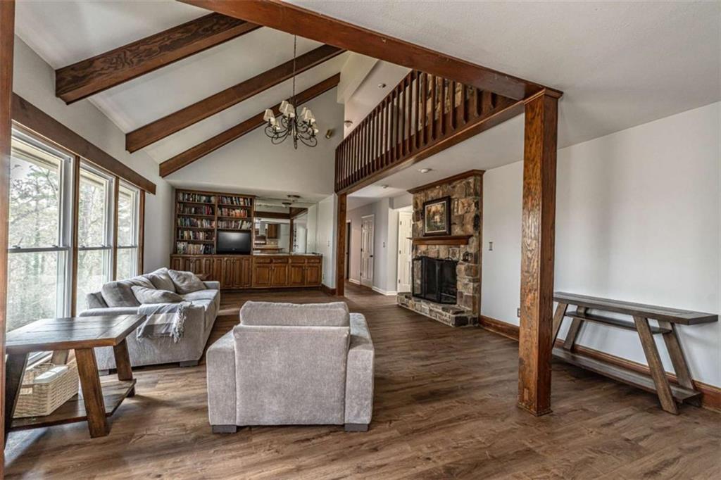 27 Saddle Mountain Road Southeast Rome, GA 30161 - Photo 8 of 36 a living room with furniture a wooden floor and a large window