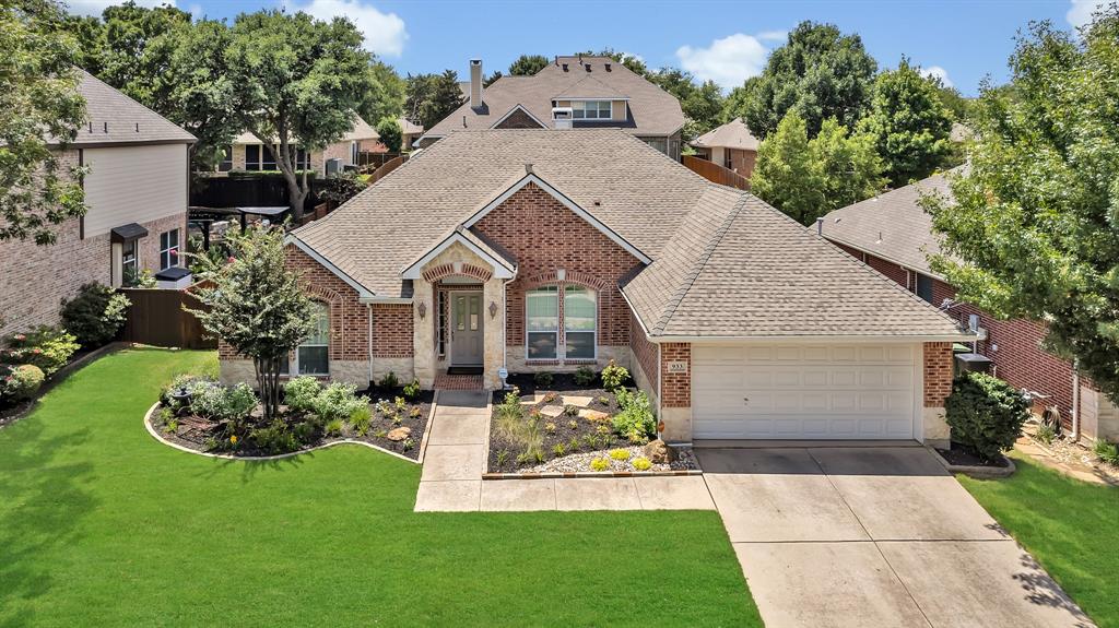 a front view of a house with a garden and plants