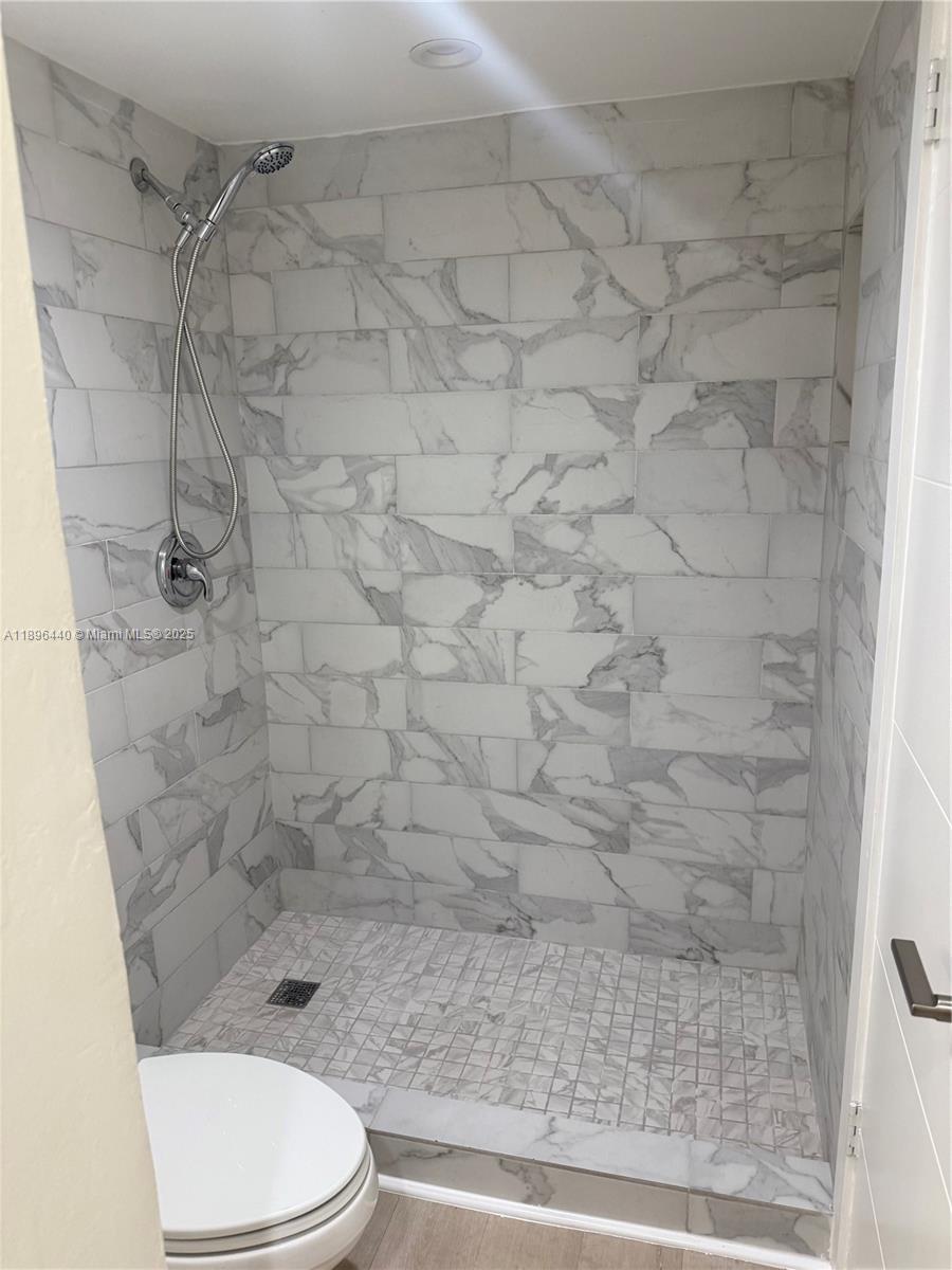 7403 Southwest 82nd Street, Unit 109N Miami, FL 33143 - Photo 12 of 16 a bathroom with a toilet and a shower