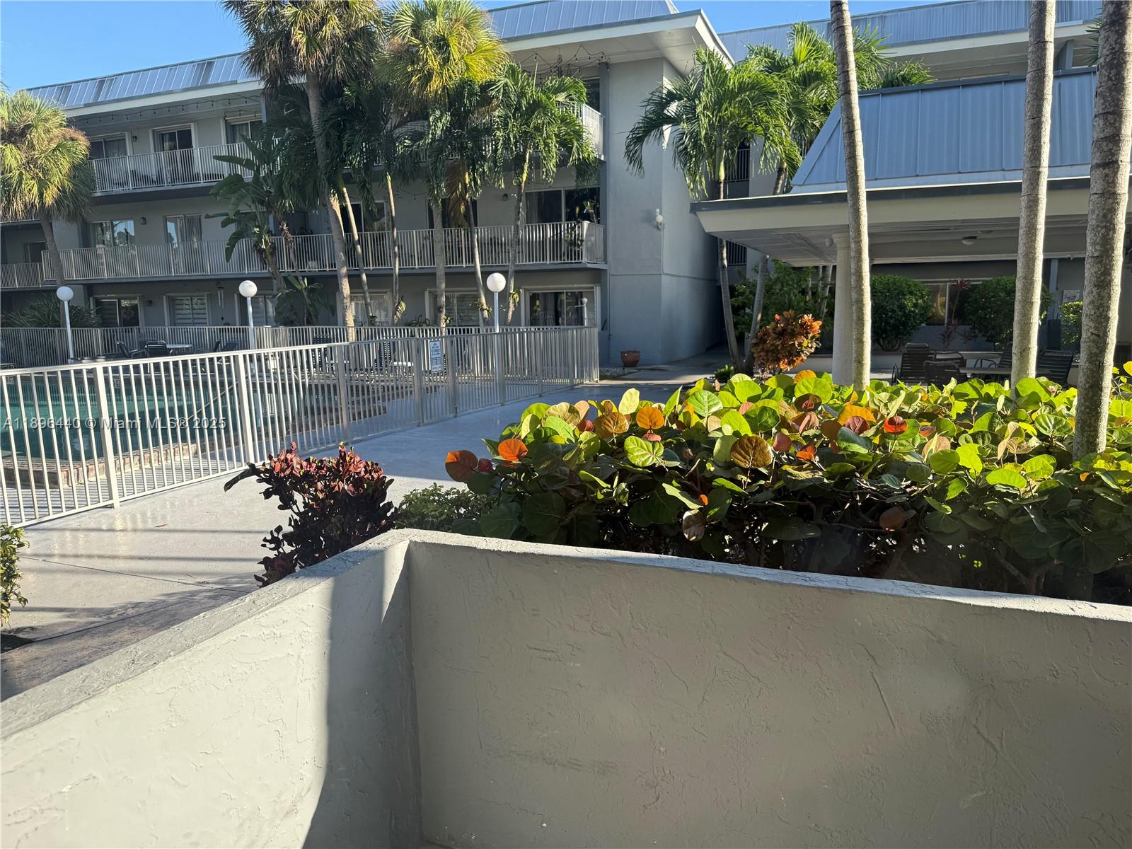 7403 Southwest 82nd Street, Unit 109N Miami, FL 33143 - Photo 13 of 16 a view of a garden with potted plants