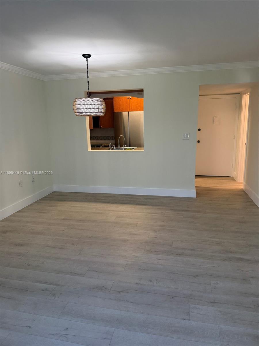 7403 Southwest 82nd Street, Unit 109N Miami, FL 33143 - Photo 4 of 16 a view of empty room with wooden floor