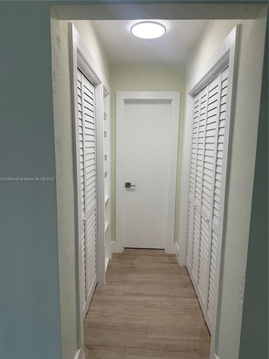 7403 Southwest 82nd Street, Unit 109N Miami, FL 33143 - Photo 7 of 16 a view of a hallway with wooden floor and closet