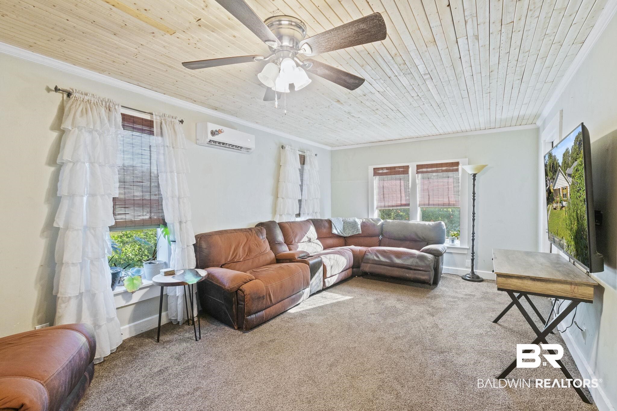 707 North Cedar Street Foley, AL 36535 - Photo 10 of 69 Living room with ceiling fan, wood ceiling, ornamental molding, carpet floors, and a wall mounted air conditioner