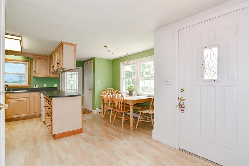 40 Eastern Avenue Lunenburg, MA 01462 - Photo 16 of 42 a kitchen with stainless steel appliances kitchen island granite countertop a refrigerator a stove and a wooden floors