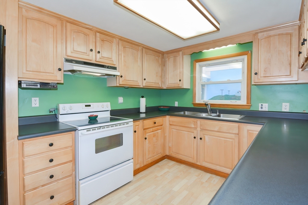 40 Eastern Avenue Lunenburg, MA 01462 - Photo 19 of 42 a kitchen with cabinets appliances a sink and a window