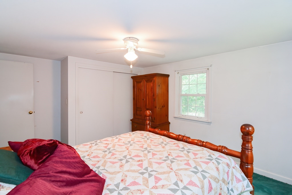40 Eastern Avenue Lunenburg, MA 01462 - Photo 28 of 42 a bedroom with a bed and a chandelier