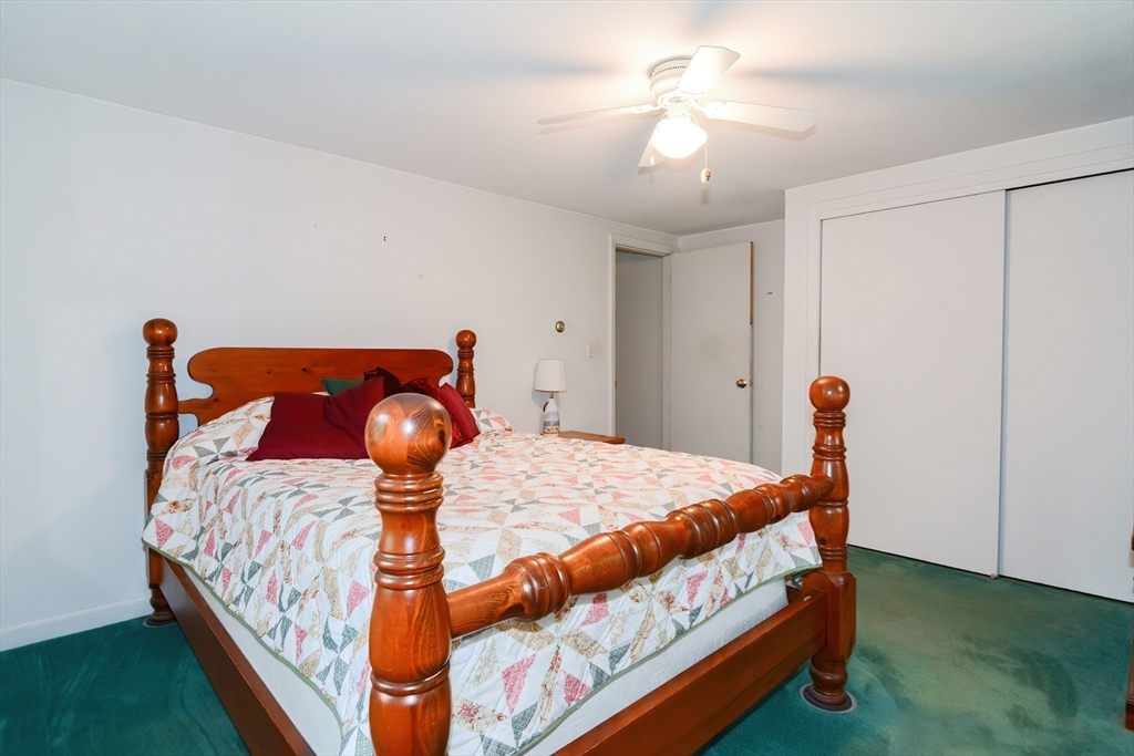 40 Eastern Avenue Lunenburg, MA 01462 - Photo 29 of 42 a bedroom with a bed and a chandelier