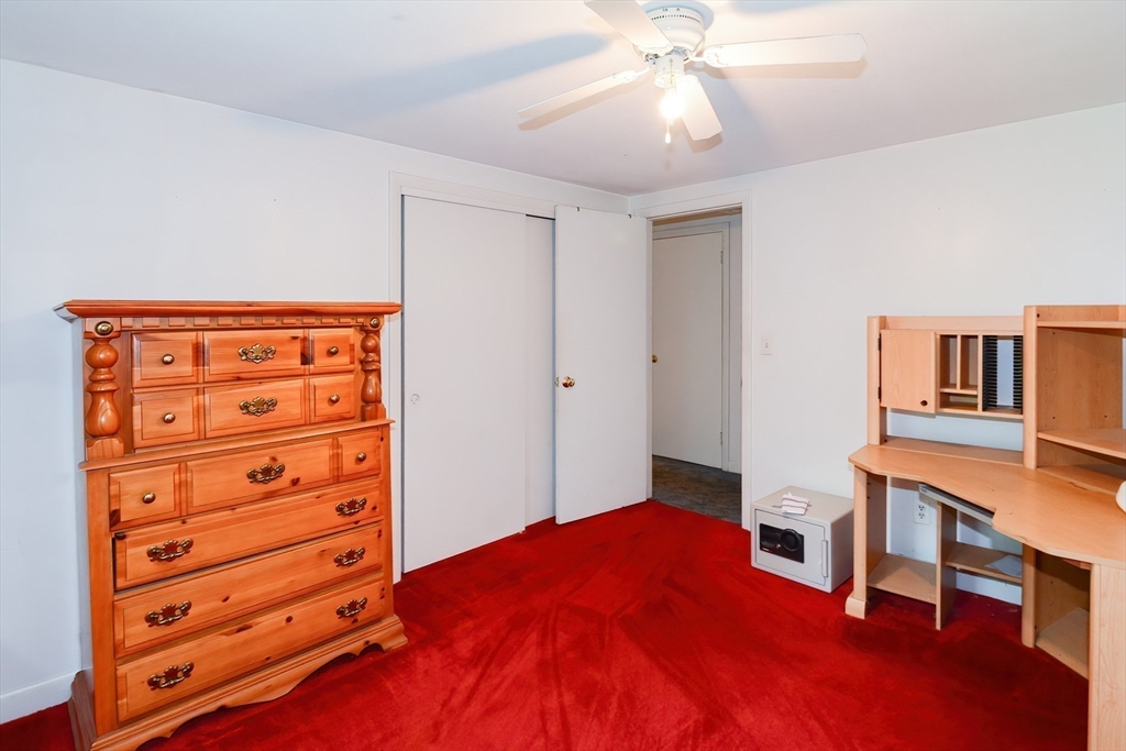 40 Eastern Avenue Lunenburg, MA 01462 - Photo 34 of 42 a bedroom with a bed and a chandelier