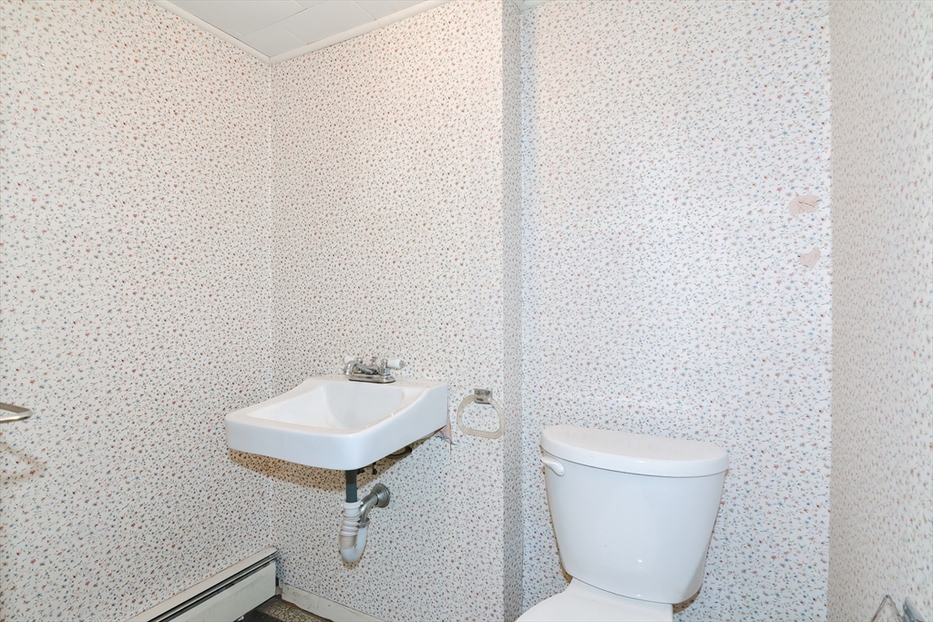 40 Eastern Avenue Lunenburg, MA 01462 - Photo 42 of 42 a bathroom with a toilet a sink and mirror