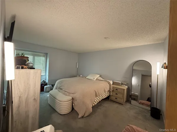 a bedroom with a bed and a chair