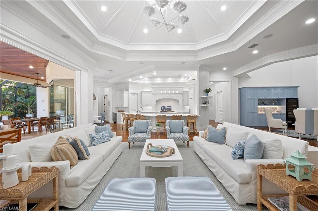 610 Springline Drive Naples, FL 34102 - Photo 1 of 49 a living room with furniture and a chandelier