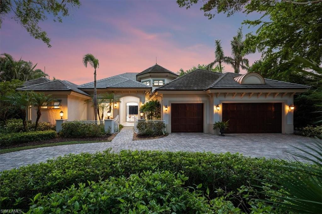 610 Springline Drive Naples, FL 34102 - Photo 12 of 49 a front view of a house with patio and yard