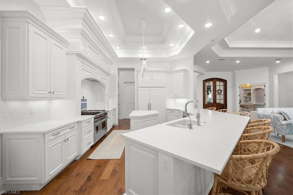 610 Springline Drive Naples, FL 34102 - Photo 14 of 49 a large kitchen with kitchen island a sink stainless steel appliances and cabinets